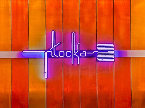 A picture of the neon metro sign on the platform at Plocka metro station in Warsaw, Poland